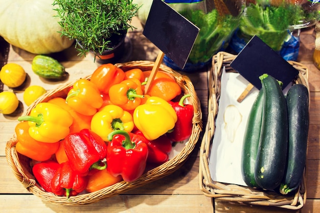 sale, shopping and eco food concept - ripe vegetables in baskets with nameplates at grocery market