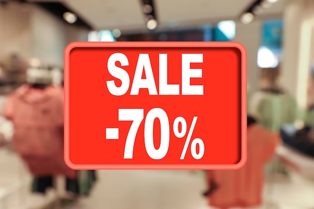 Sale sign and blurred view of fashion store with clothes