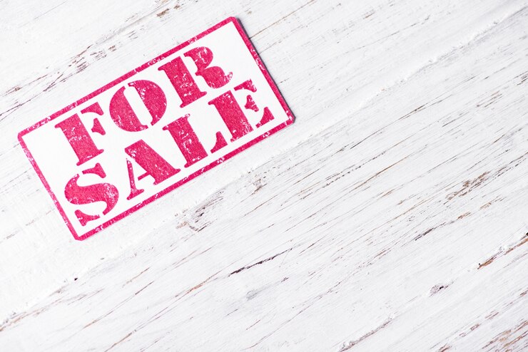Photo for sale sign on white wooden background
