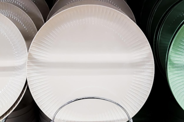 Sale of tableware in store Ceramic plates on shelf in supermarket Eco tableware in trendy neutral colors