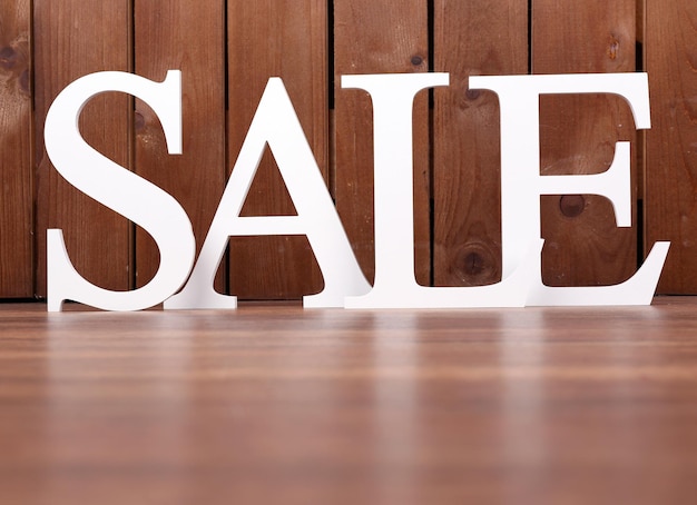 Sale on wooden background