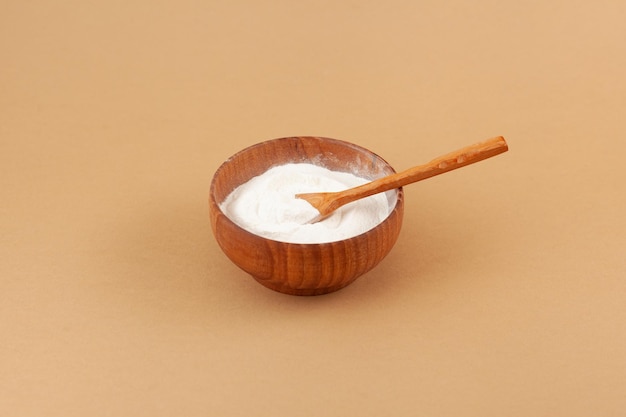 Photo salep powder in wooden bowl salep also spelled sahlep or sahlab is flour made from tubers of orchid