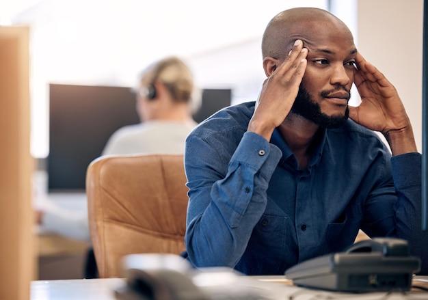 Sales can be a stressful too Shot of a young call centre agent looking stressed out while working on a computer in an office