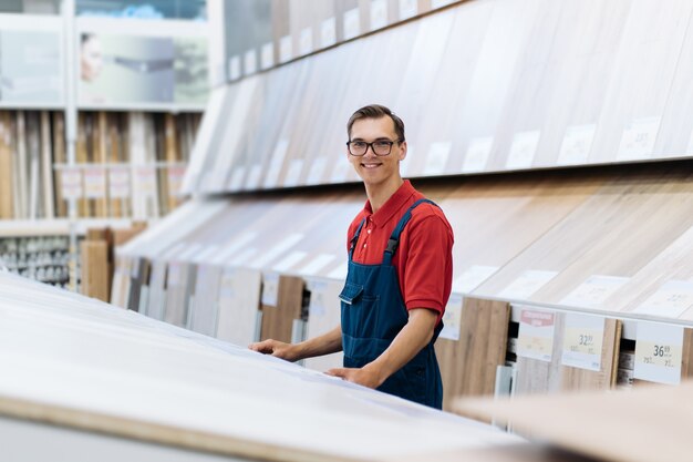 Sales consultant of the floor coverings store standing in the\
sales area