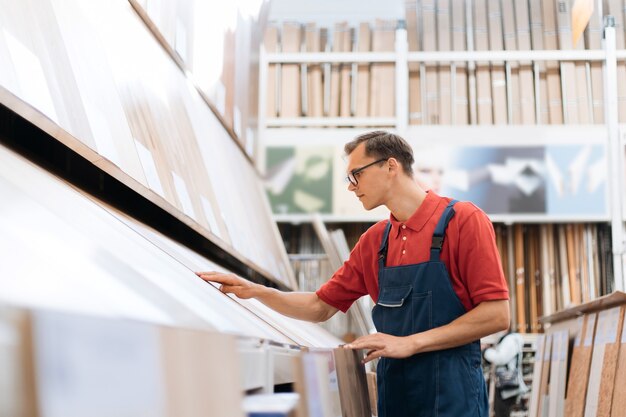 Sales consultant inspecting samples of floor coverings