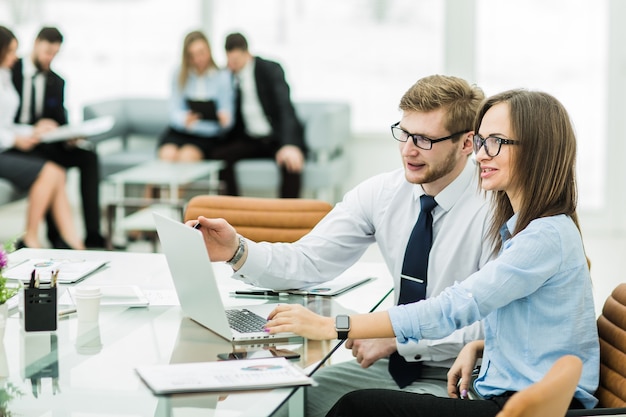 Sales manager and accountant are working on a laptop with financ