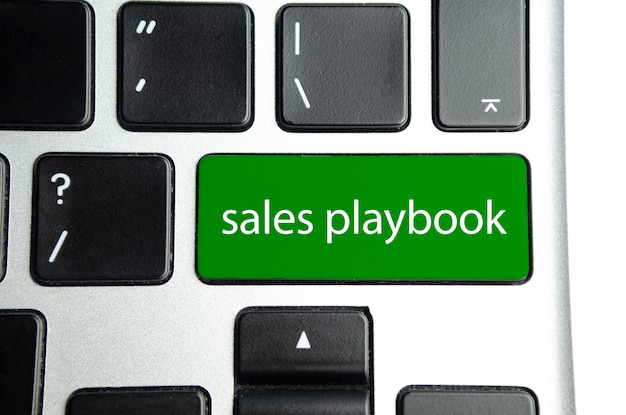 Sales playbook word on green button keyboard Business concept