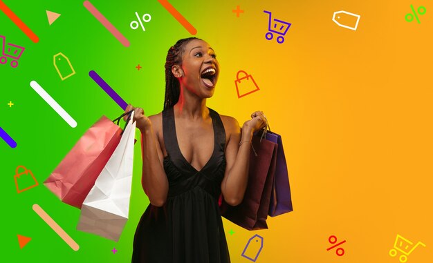 Sales, shopping. African woman portrait with packages. Beautiful female model in casual. Concept of human emotions, facial expression, sales, ad, copyspace. Bright, modern illustrated background.