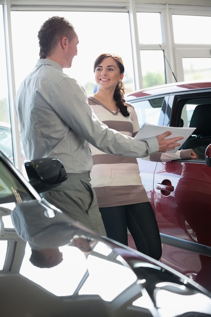 Salesman showing document to a woman