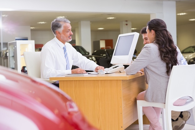 Salesman speaking with a smiling couple