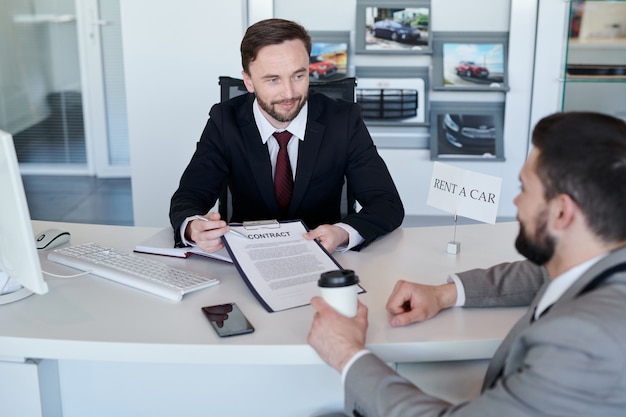 Salesman with contract of rent a car
