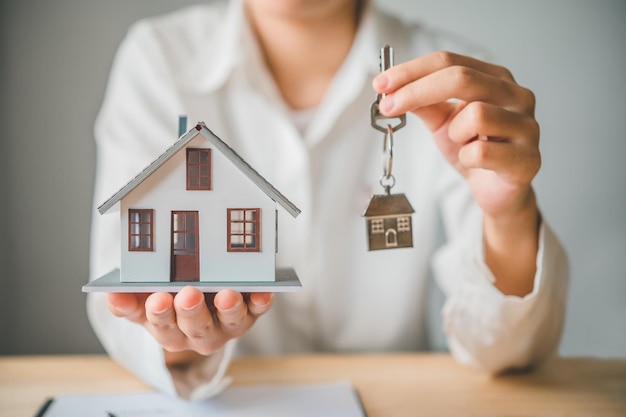 Salesperson Concept of holding house keys house keys for a new home new home purchase a loan agreement for real estate a loan deal for real estate a loan agreement for real estate