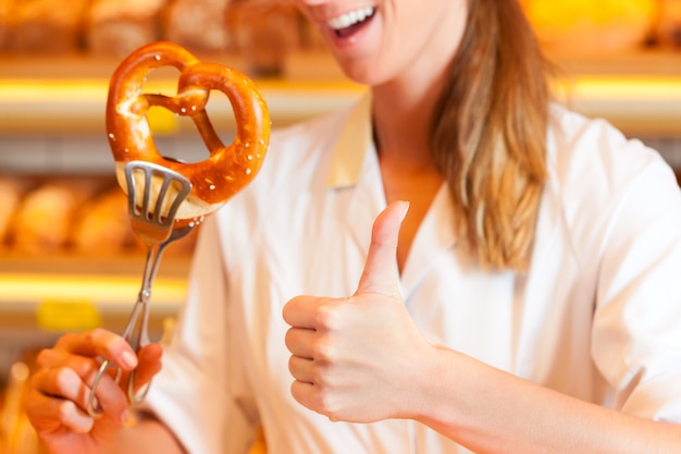 Salesperson is packing bread in bakery