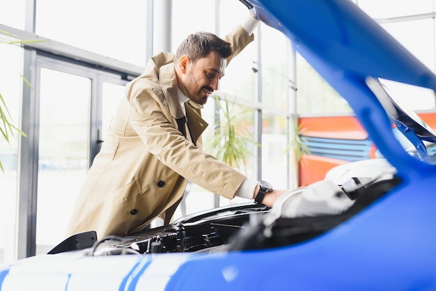 Salesperson selling cars at car dealership