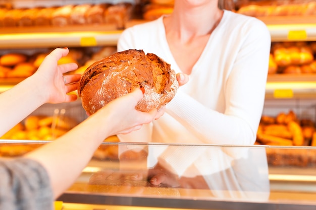 Salesperson with female customer in bakery