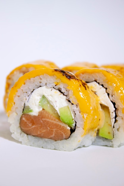 salmon avocado philadelphia sushi roll with cheese on it