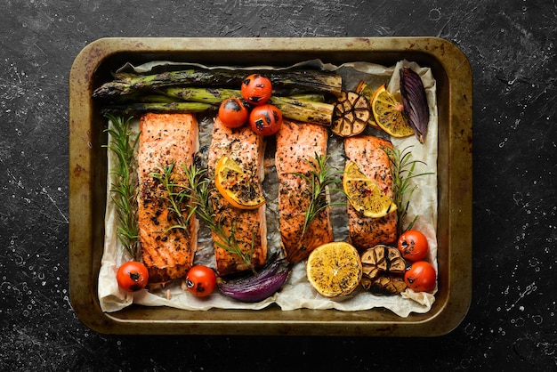 Salmon baked in a metal tray with vegetables and rosemary Recipe Seafood Free space for text