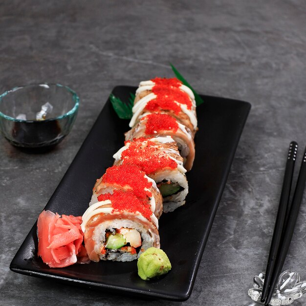 Salmon Blaze Sushi Roll, Crab Stick, Cucumber, and Roast Salmon Topped with Tobiko.