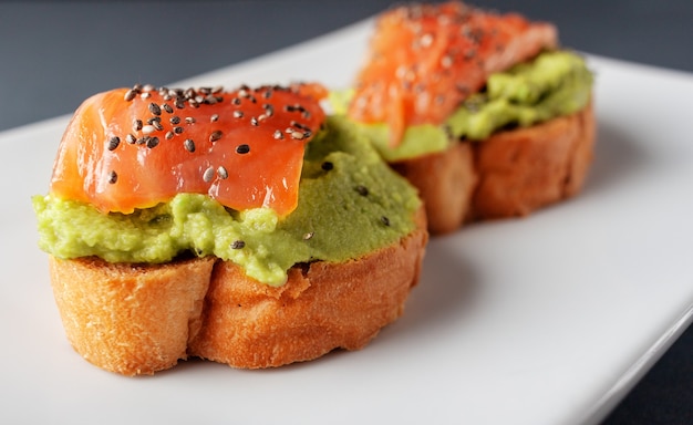 Salmon bruschettas with avocado and seeds