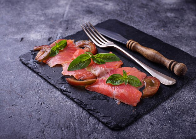 Salmon carpaccio with basil and tomato