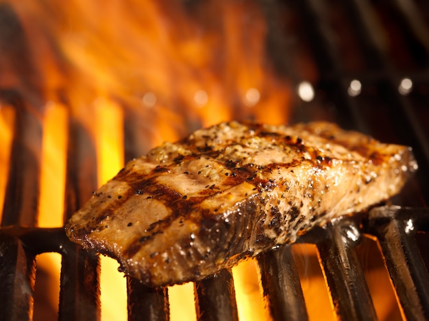 Salmon fillet on the grill with flames