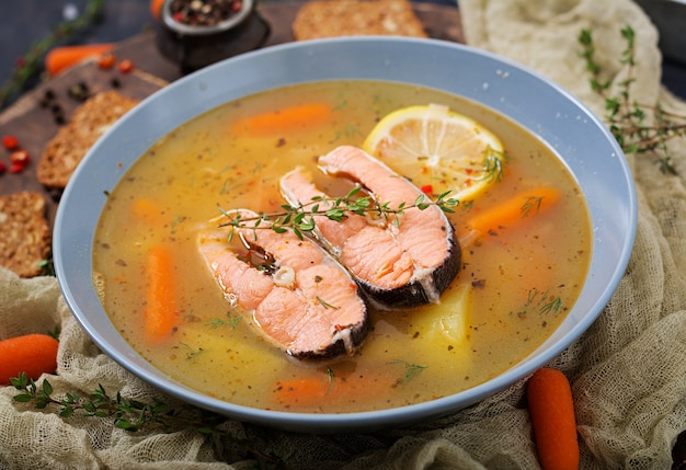 Salmon fish soup with vegetables in bowl