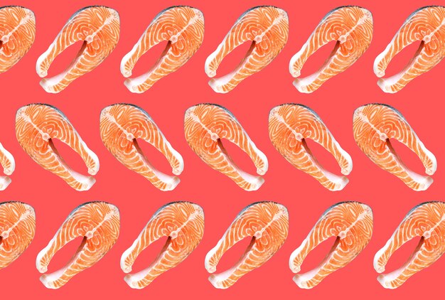 Photo salmon fish steaks isolated on pink background. omega 3 vitamin, healthy lifestyle. natural vegetarian food. top view.