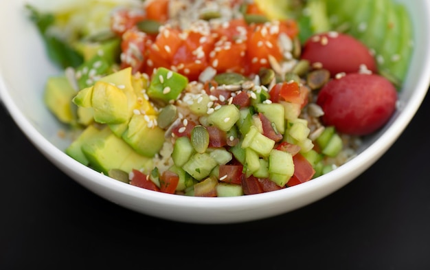 Salmon fresh vegetable salad of tomato avocado cucumber Healthy and detox food