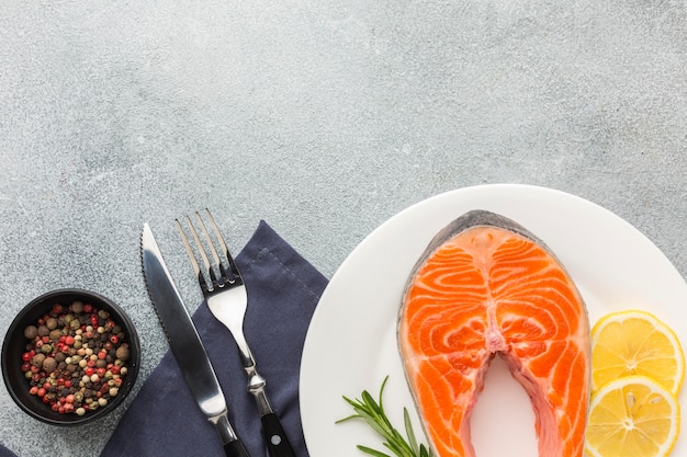 Salmon and lemon on plate top view