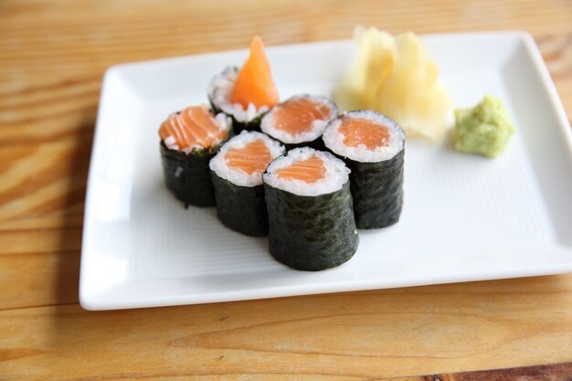 Salmon Maki sushi on wood background