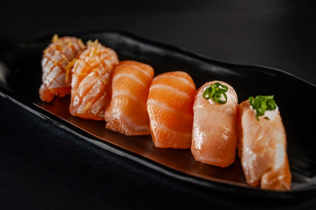 Salmon onigiri varieties Blowtorcherd salmon onigiri and salmon onigiri on a black background