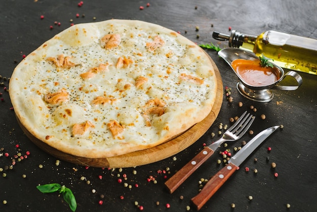 A salmon pizza on black background