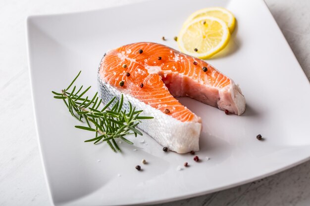 Salmon raw salmon steak with rosemary lemon salt and pepper