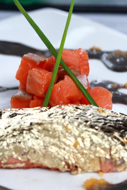 Salmon raw with and edible gold leaf