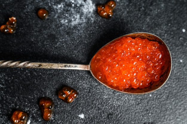 Salmon red caviar in an exquisite spoon. Top view