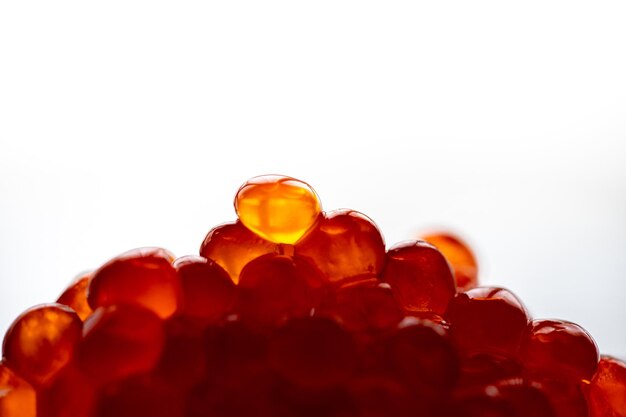 Salmon Red caviar white background. Luxury delicacy food. Raw seafood. Macro fish caviar.