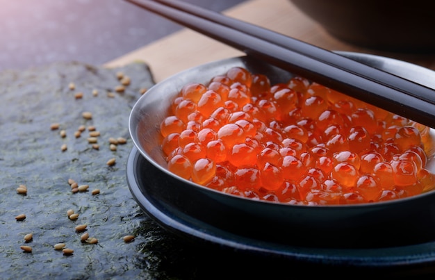 Salmon roe in metal cup.