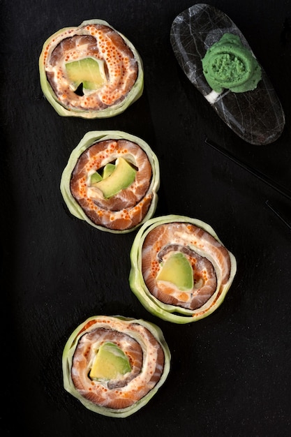 Salmon roll with avocado and caviar wrapped in cucumber