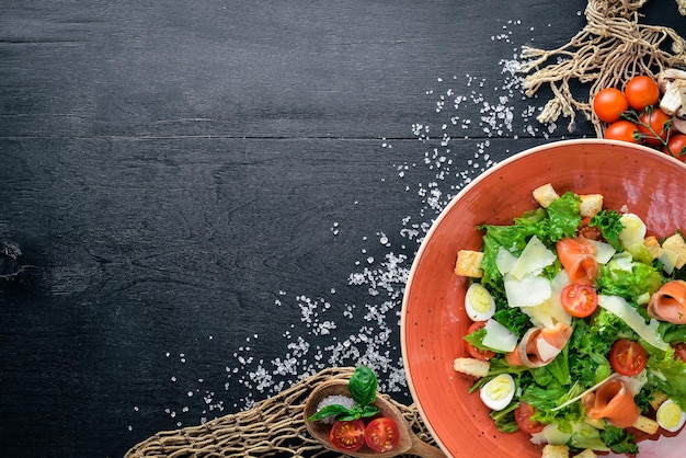 Salmon Salad and Fresh Vegetables On a wooden background Top view Free space for your text