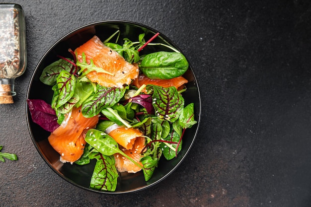 Salmon salad slices fish green salad mix leaves seafood fresh healthy meal food diet snack