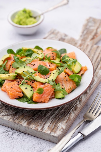 Salmon salad with avocado for keto and low carb diet Rusty background top view copy space