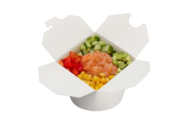 Salmon salad with vegetables in a white paper box Ready food delivery closeup studio shot