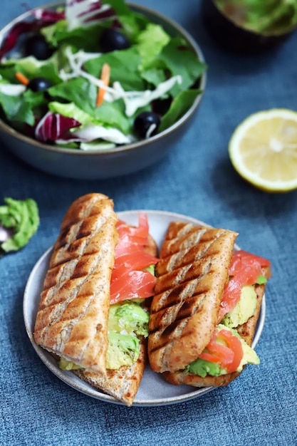 Salmon sandwich with avocado and lettuce