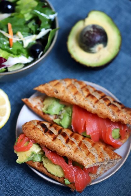 Salmon sandwich with avocado and lettuce