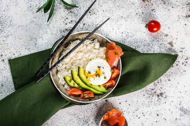Salmon Sashimi Rice Bowl with Avocado. Healthy food for diet. Healthy bowl. Modern food. Healthy nutrition. Copy space. Salmon, poached egg