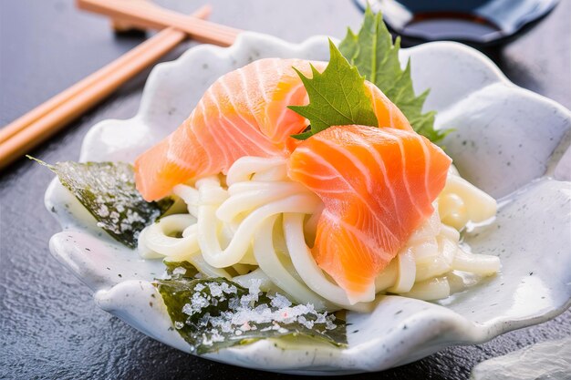 Photo salmon sashimi with nori salt and udon noodle knots