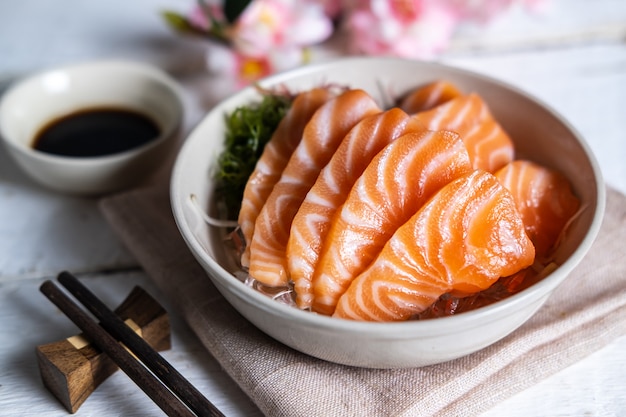 Salmon sashimi with soy sauce, raw fish in traditional Japanese style