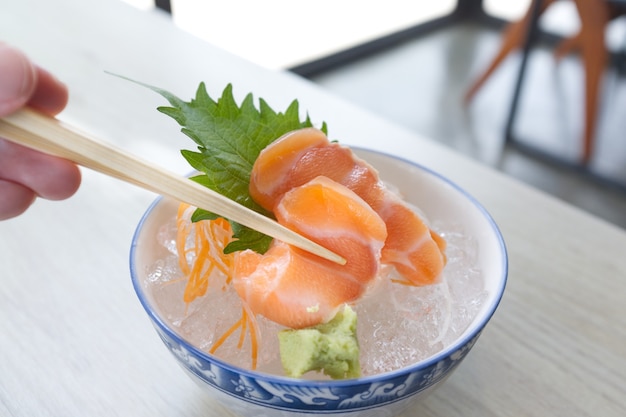 Salmon slice or salmon sashimi in Japanese style fresh serve on ice with fresh wasabi