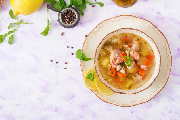 Salmon soup with vegetables in bowl