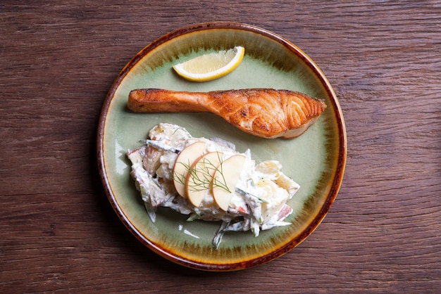 Salmon steak with fruit salad